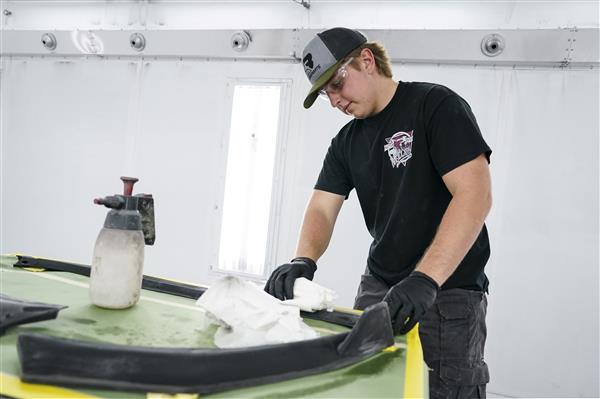 Collision Repair Technology students working on cars